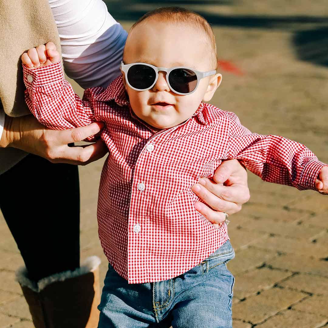 Babiators original keyhole sunglasses in clean slate being worn by baby