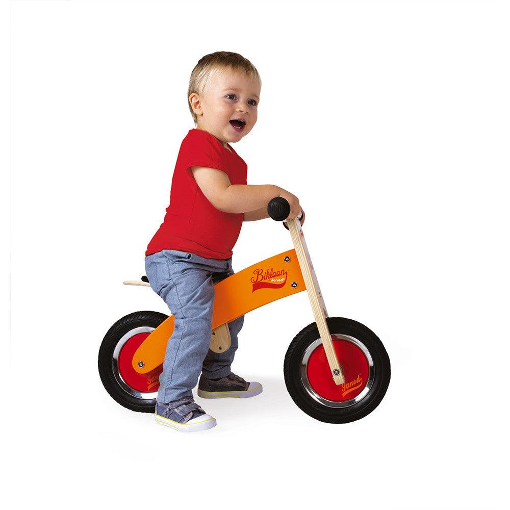 Janod My First Orange and Red Little Bikloon Balance Bike being Ridden Picture