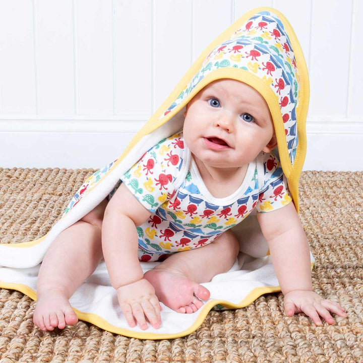 Kite eco-friendly GOTS certified organic cotton splash stripe cuddle wrap being worn