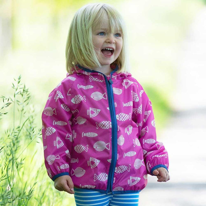 Kite Clothing Recycled Polyester Puddlepack Rain Jacket in Pink Being Worn Picture