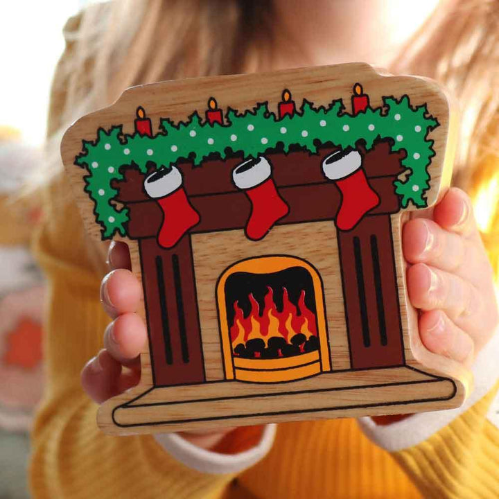 Lanka Kade Natural Wooden Colourful Fireplace with Stockings Christmas Figure Being Held Picture